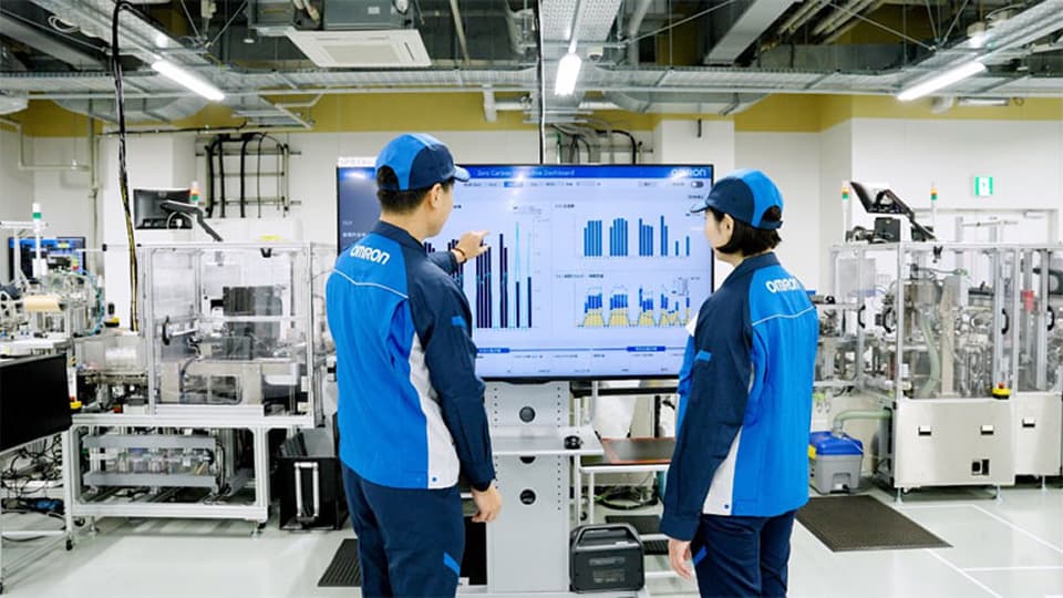 オムロン担当者がモニター上のデータを見ながら現場と対話する様子
